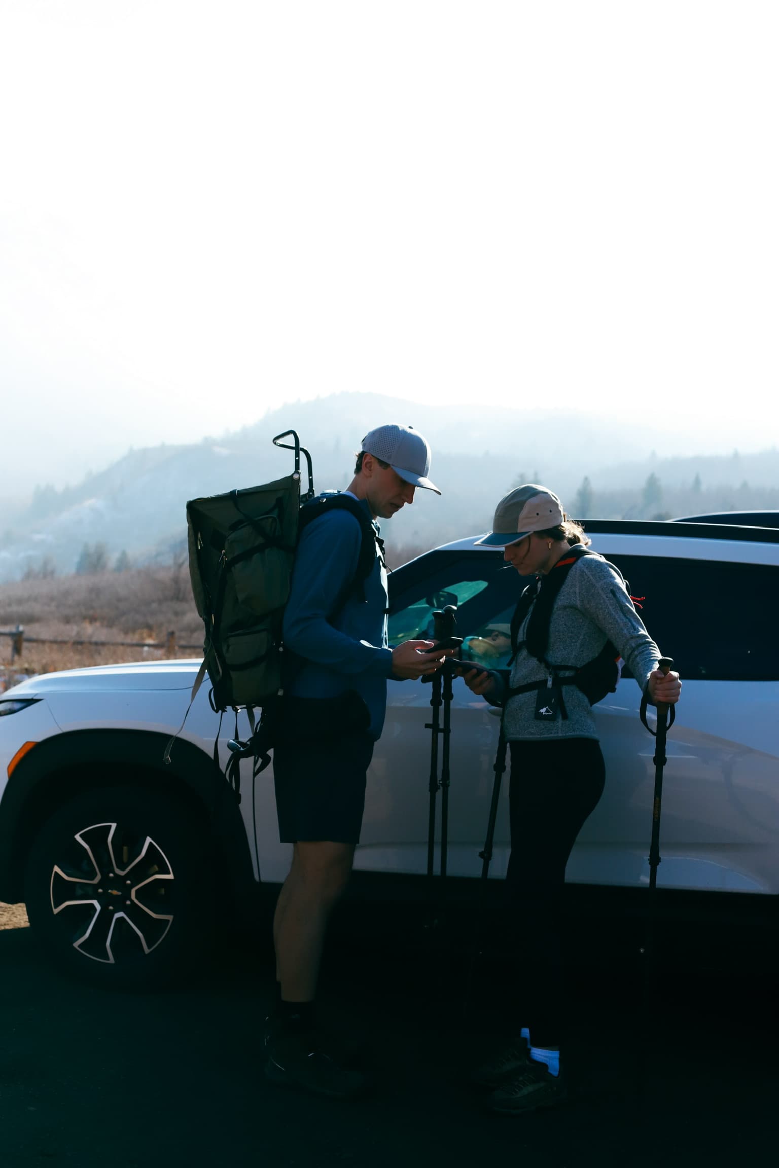 Hikers checking Kiba device at trailhead