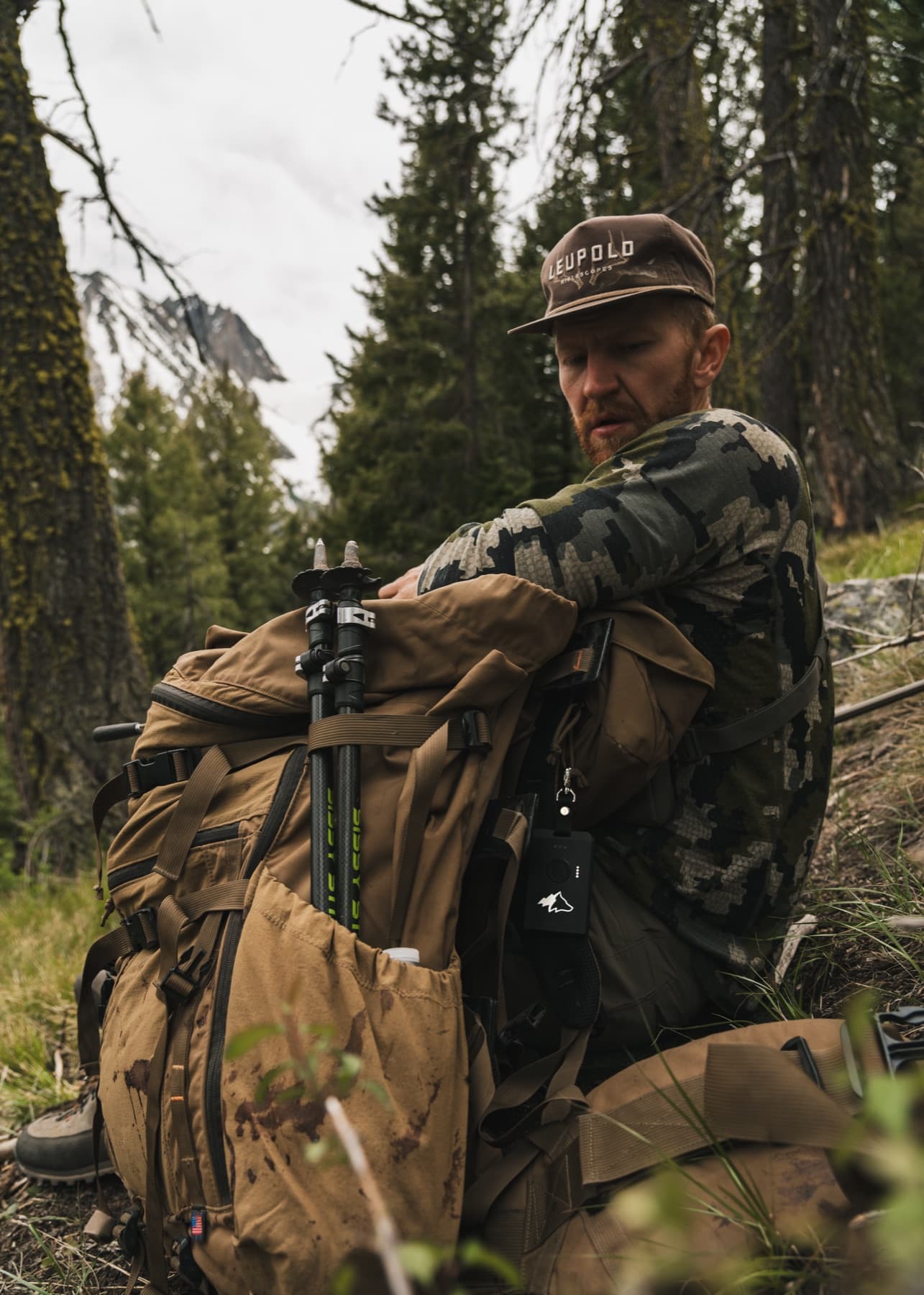 Hunter with a loaded pack in the timber